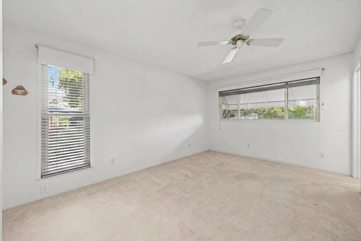 Carpeted bedroom with two windows