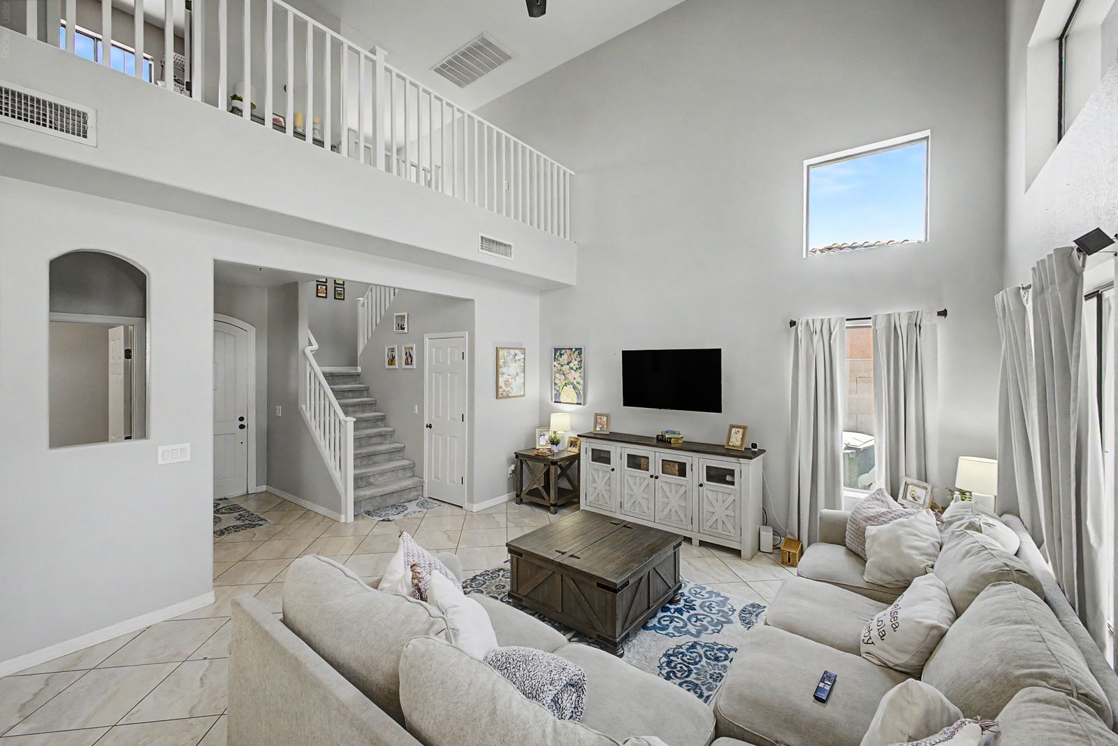 Two-story great room with loft overlook and sectional seating