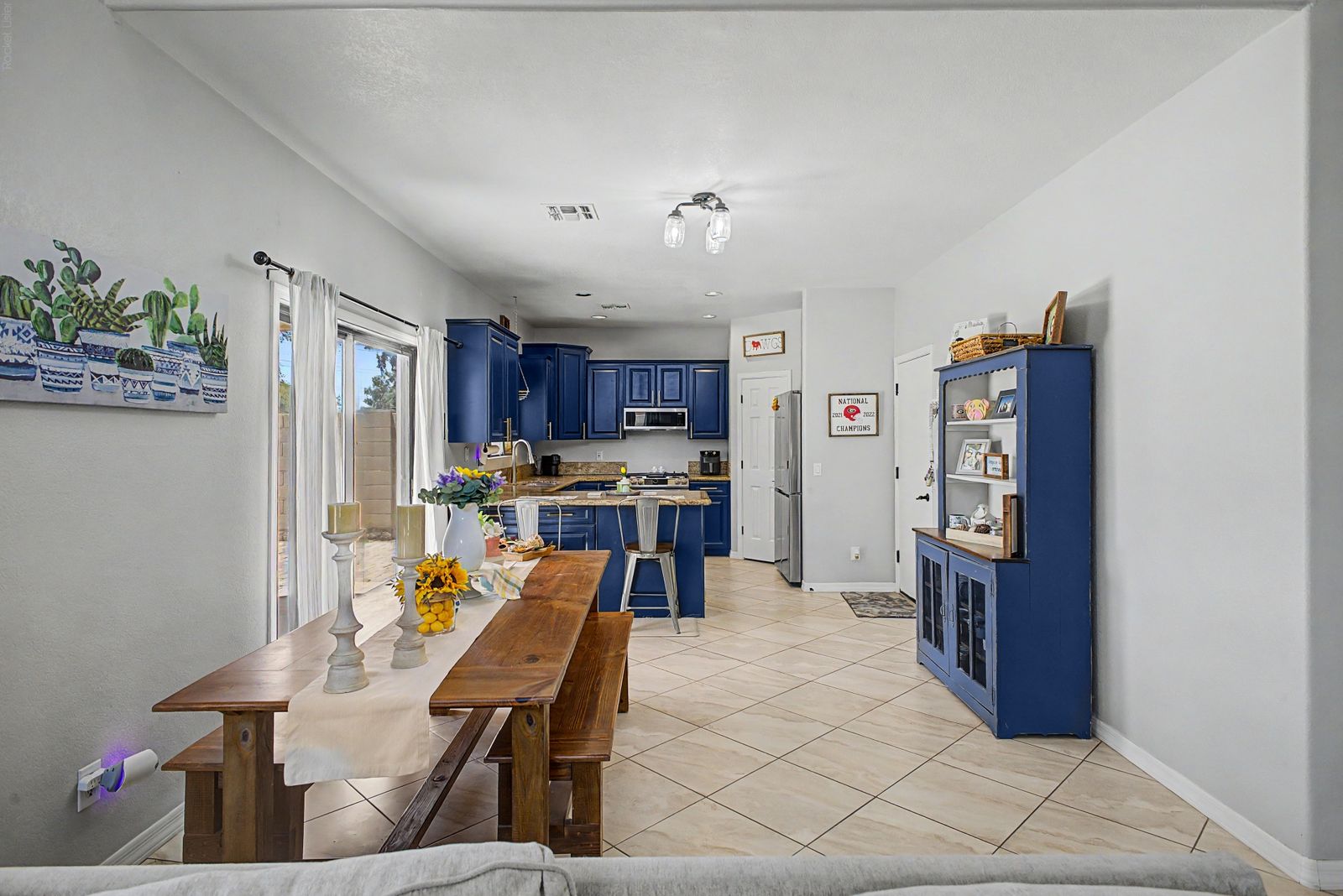 Dining area and kitchen with navy cabinetry