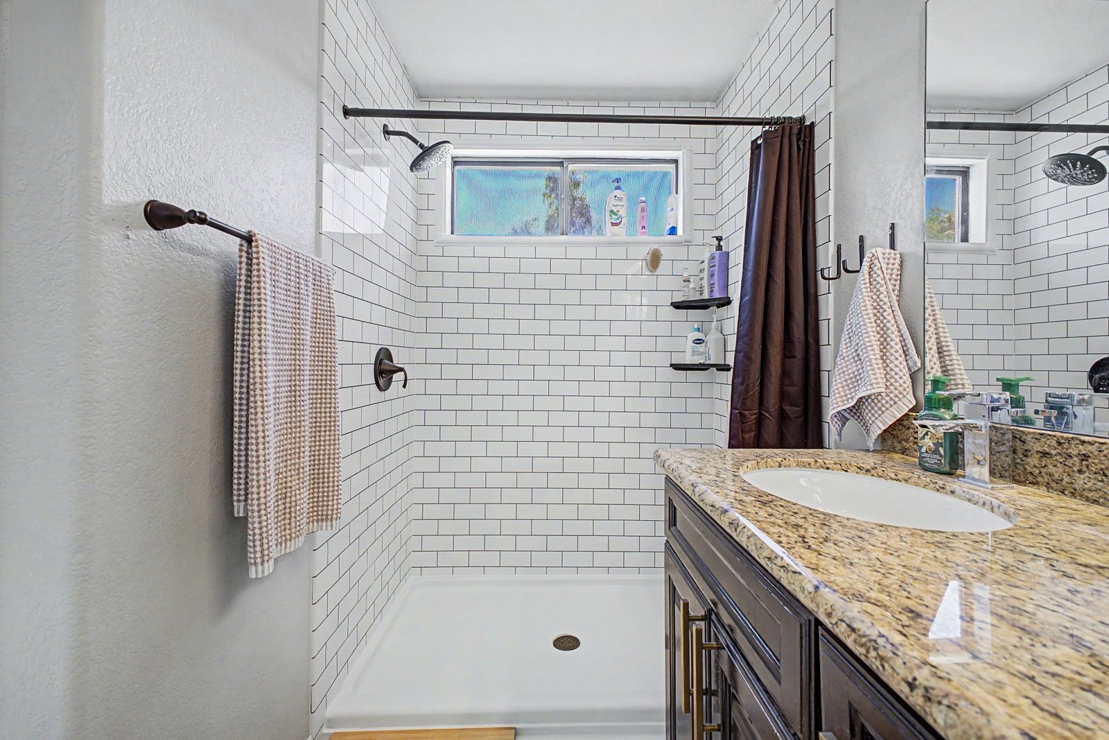 Primary bathroom with subway-tile walk-in shower