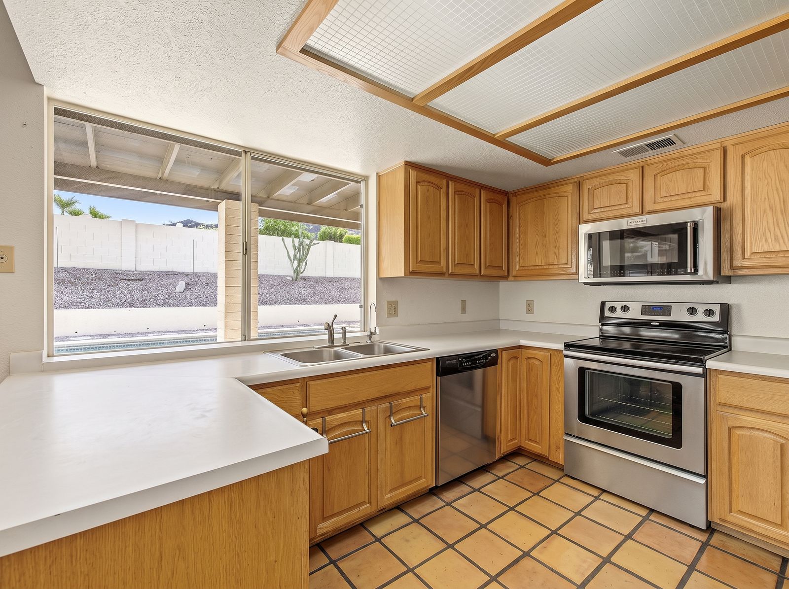 Kitchen with a window over the sink to the covered patio