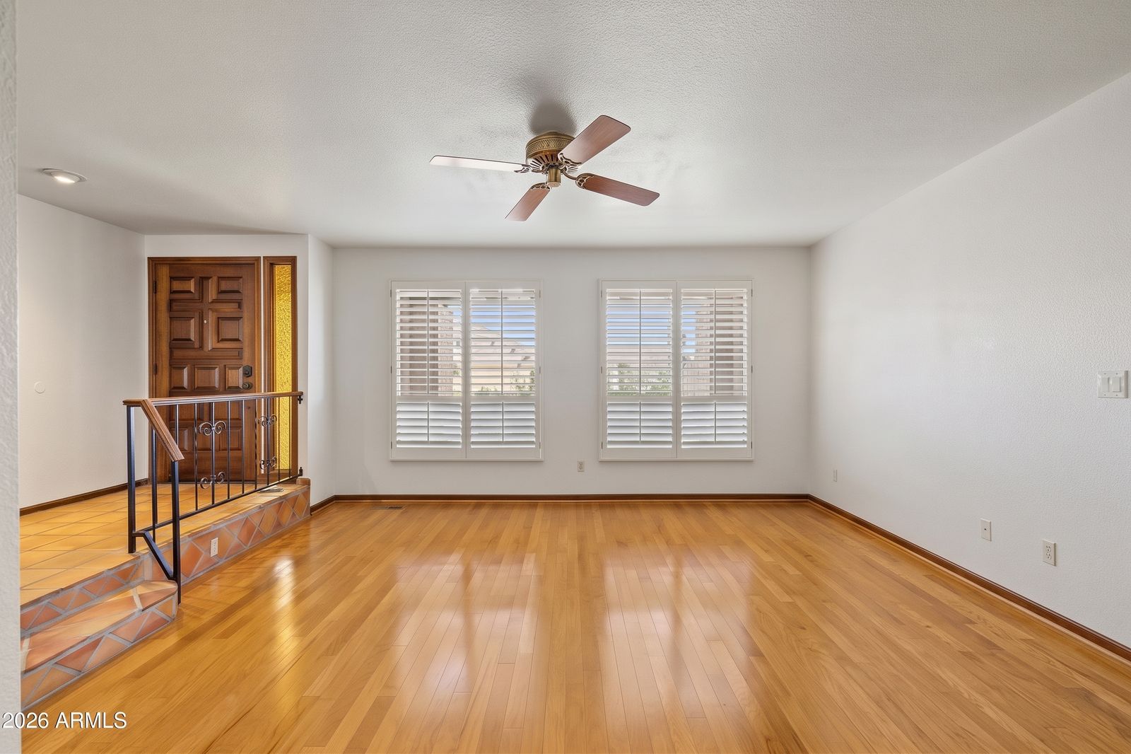 Living room with wood floors and plantation shutters