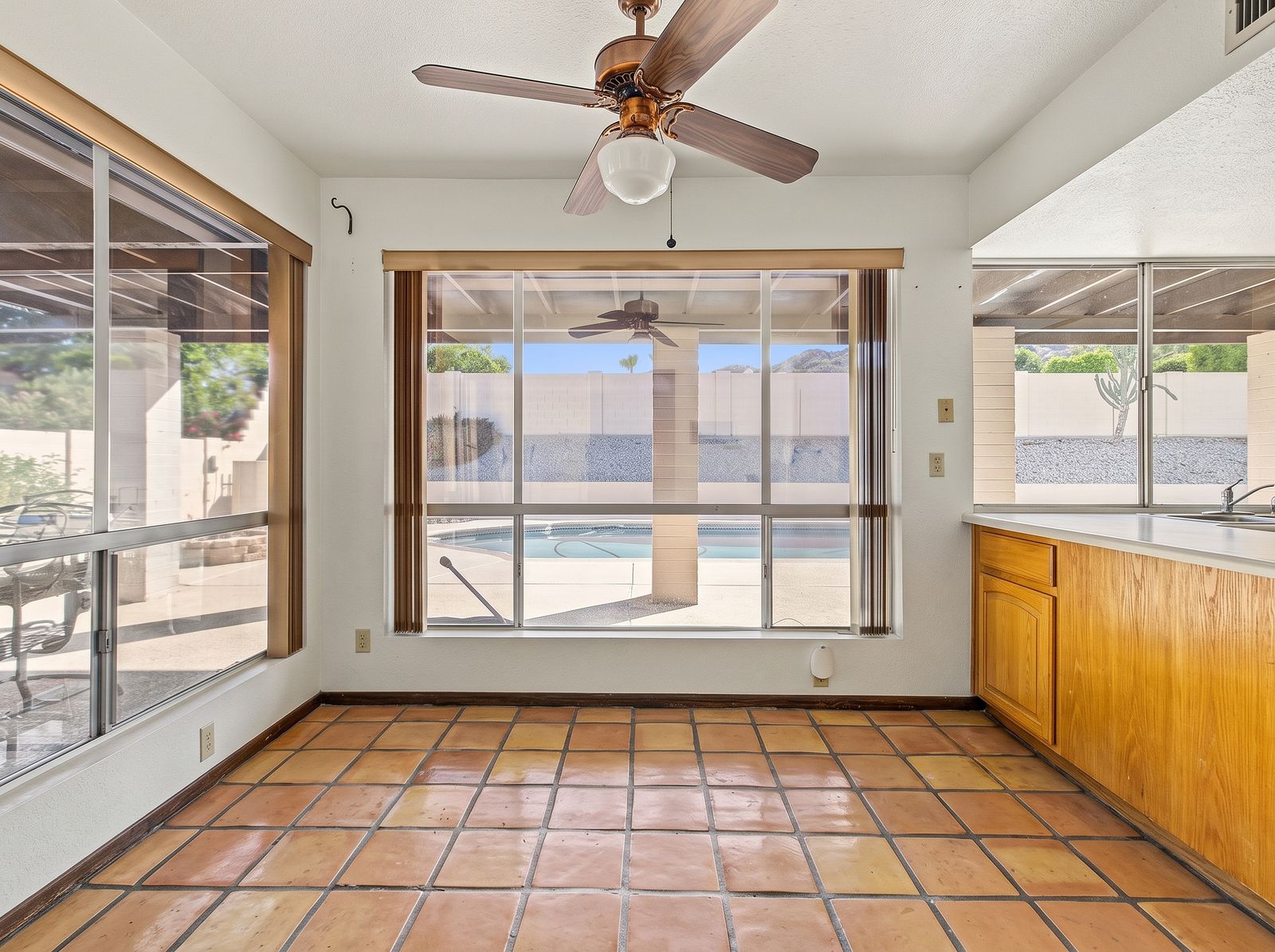 Eat-in breakfast nook with windows to the covered patio and pool